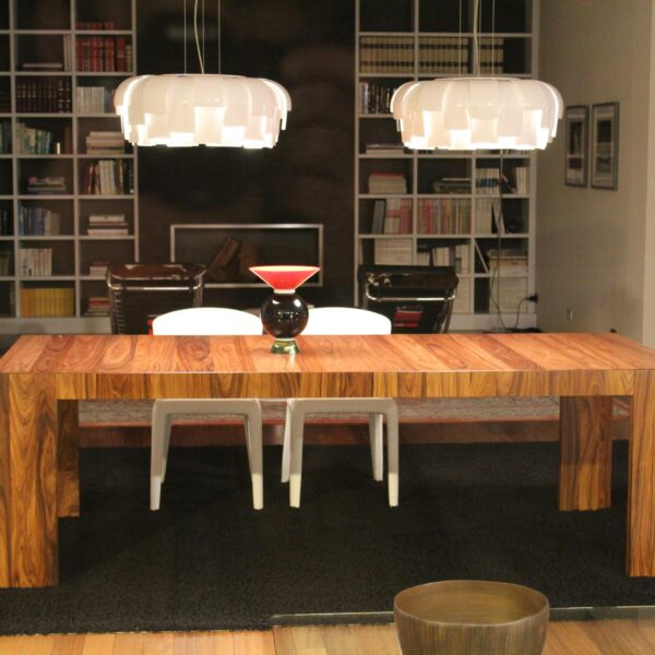 Luxurious living room featuring a modern wooden table under stylish pendant lights.